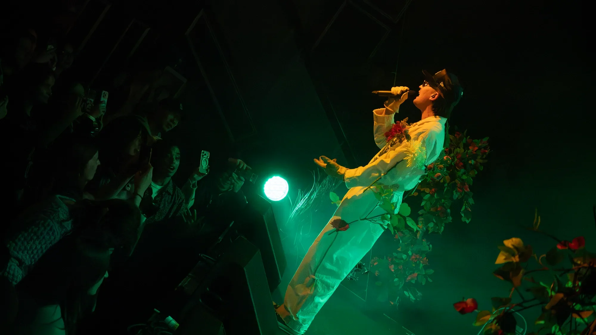 gnash sings toward the front row under green lighting at The Pearl.