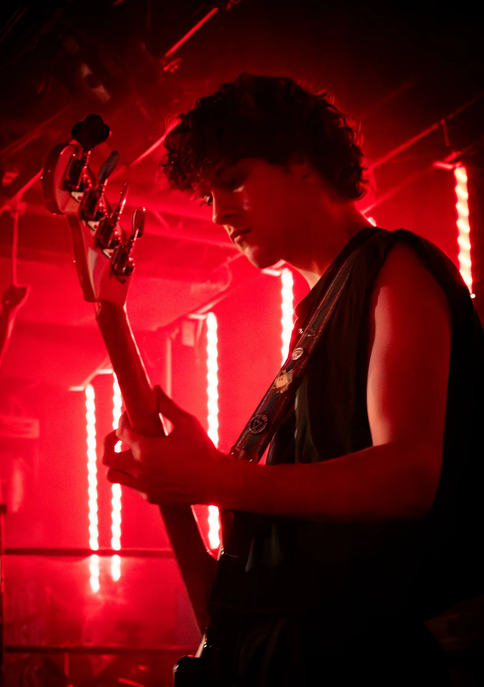 Eden performing under red stage lights at The Roxy Cabaret.