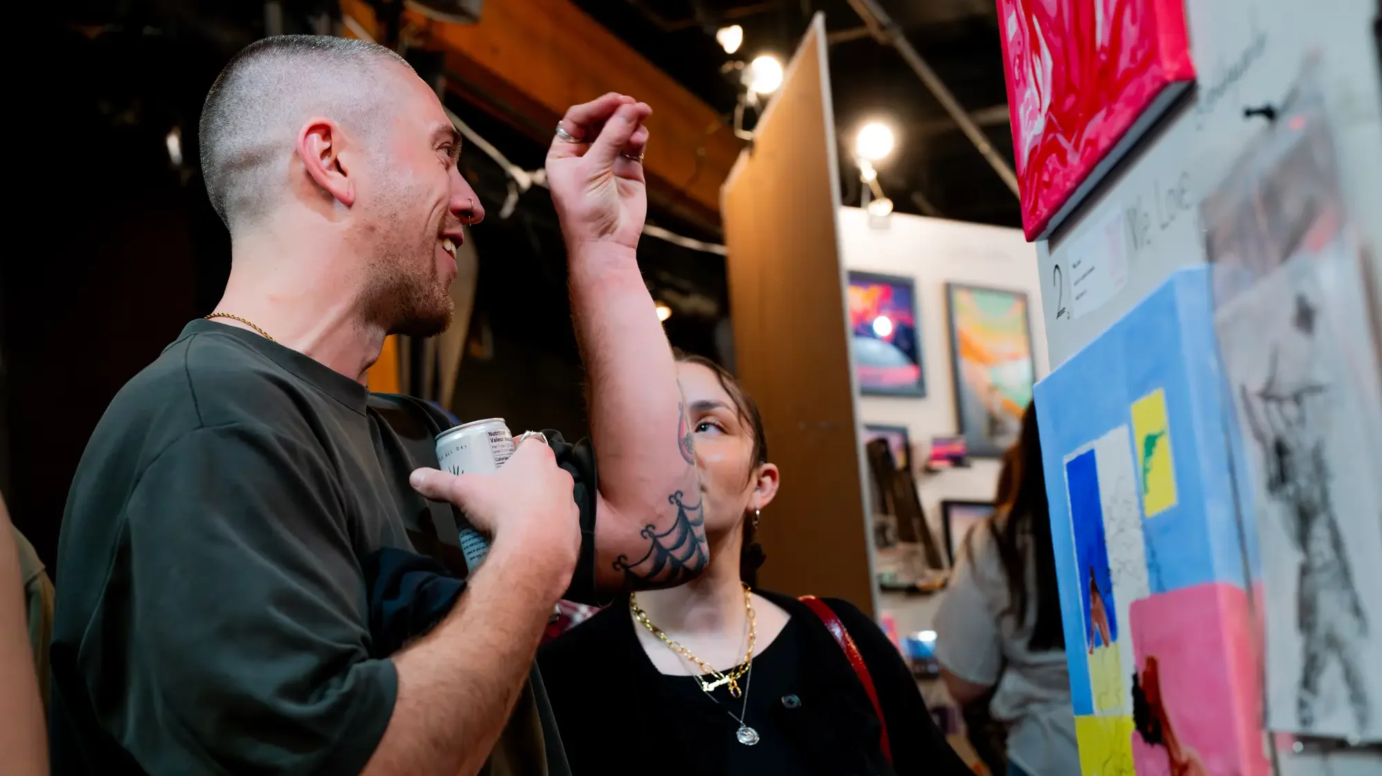 Artists and attendees in conversation on the show floor
